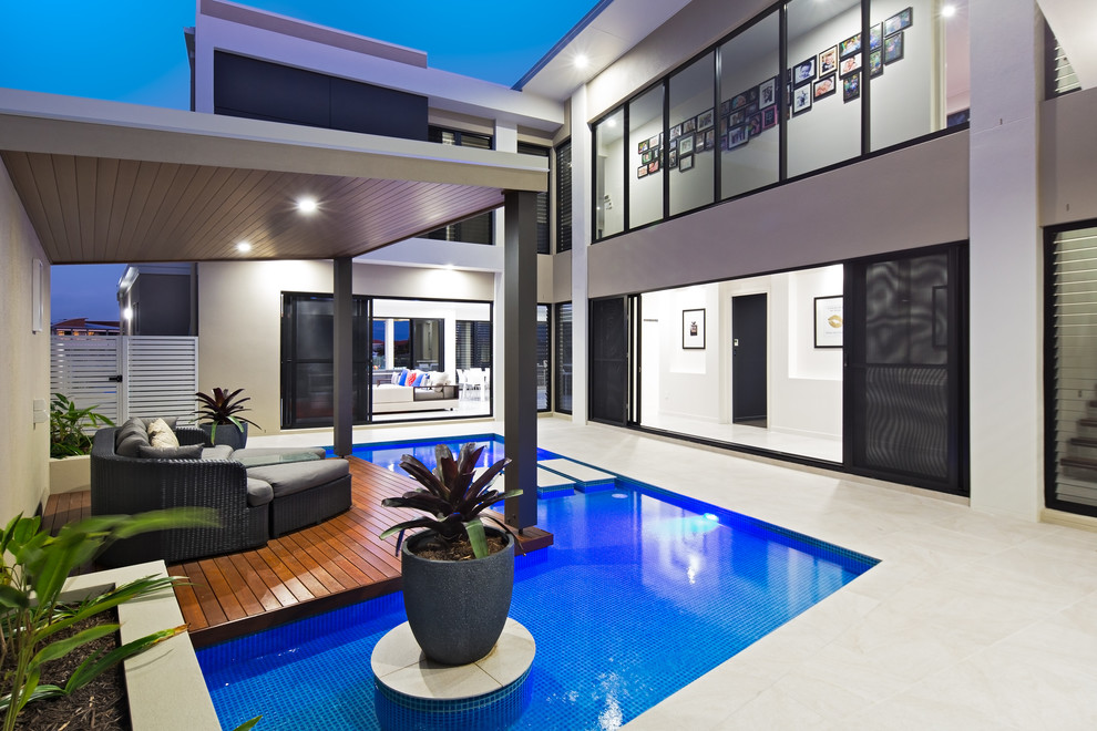 This is an example of a contemporary backyard custom-shaped pool in Brisbane.