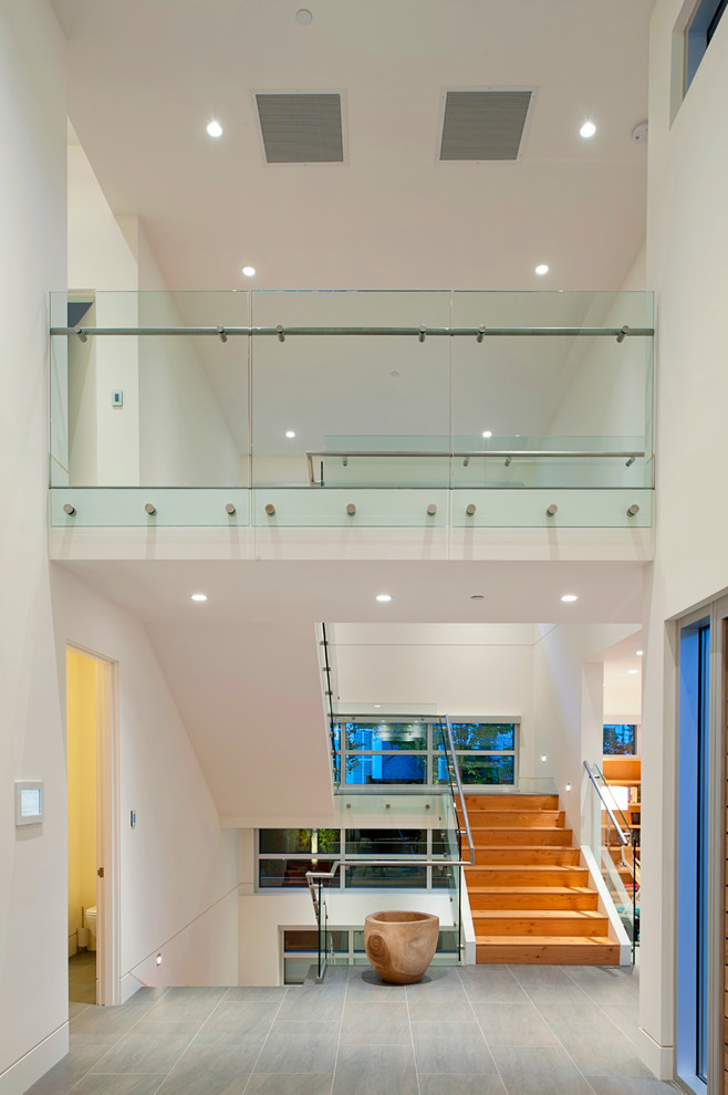This is an example of a contemporary entryway in Vancouver with white walls.