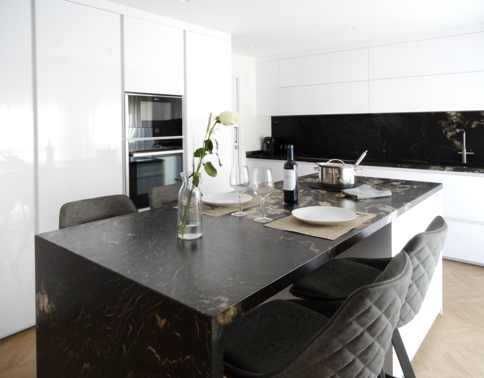 Inspiration för avskilda, mellanstora moderna svart kök, med släta luckor, vita skåp, en köksö och marmorbänkskiva