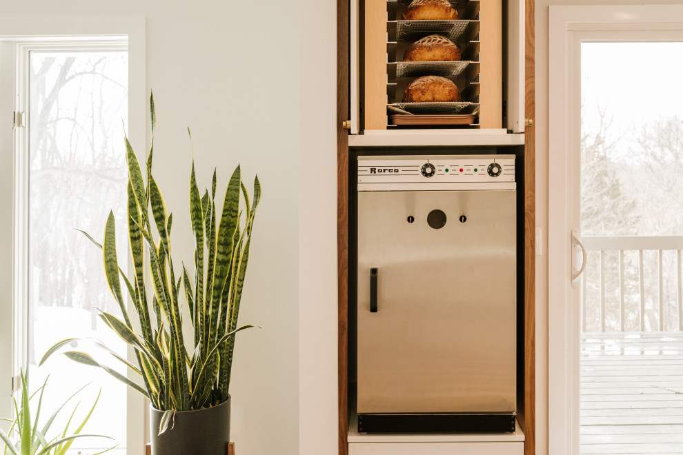 Mid-sized midcentury open plan kitchen in Minneapolis with flat-panel cabinets, medium wood cabinets, wood benchtops, multi-coloured splashback, ceramic splashback, with island and white benchtop.