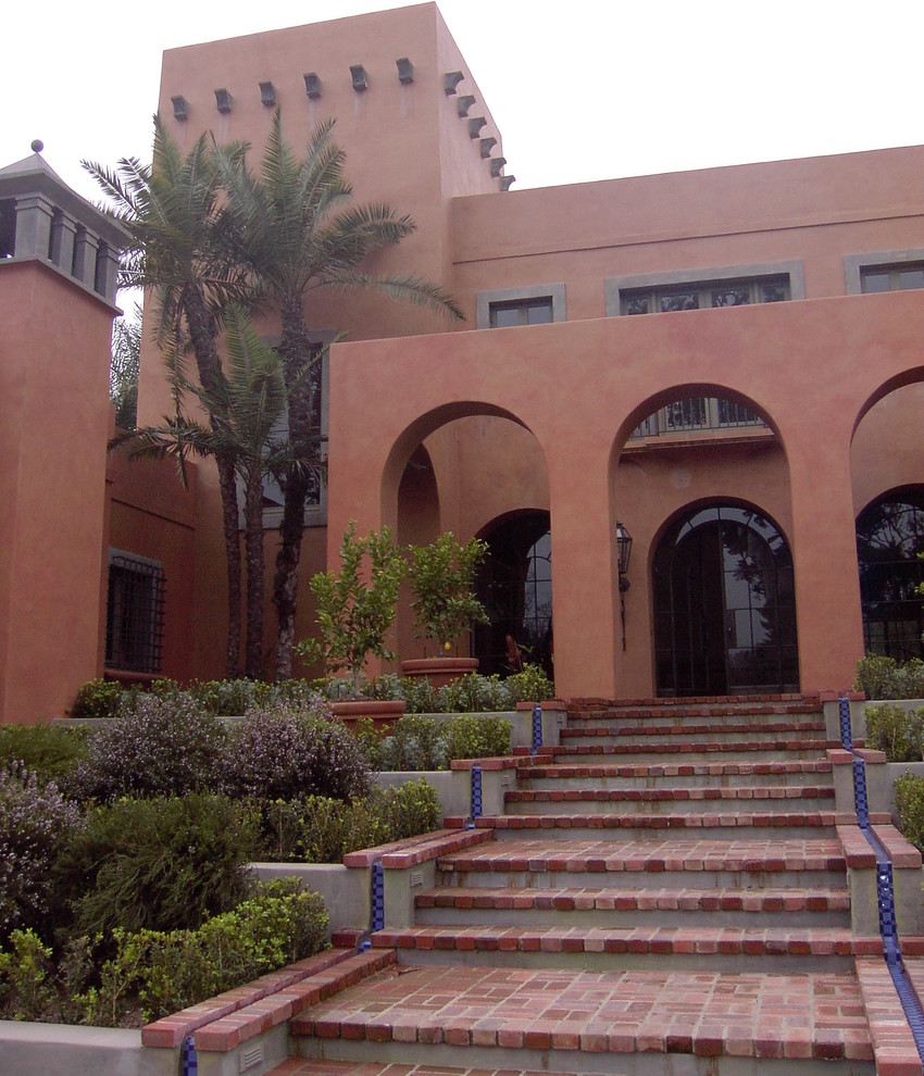 Photo of a large mediterranean three-storey stucco red exterior in San Francisco with a flat roof.
