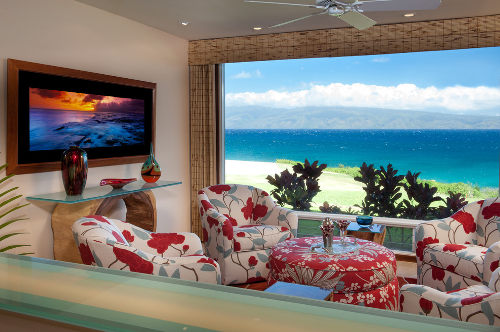 Photo of a tropical open concept family room in Hawaii with beige walls and porcelain floors.