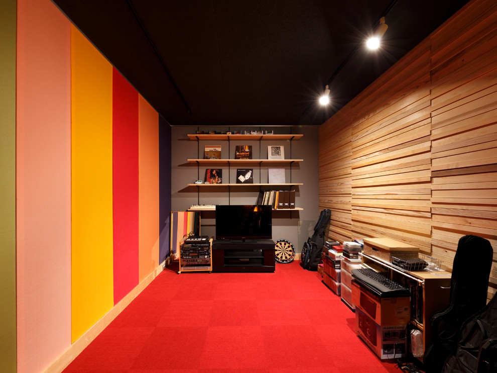This is an example of a traditional enclosed home theatre in Other with multi-coloured walls and red floor.