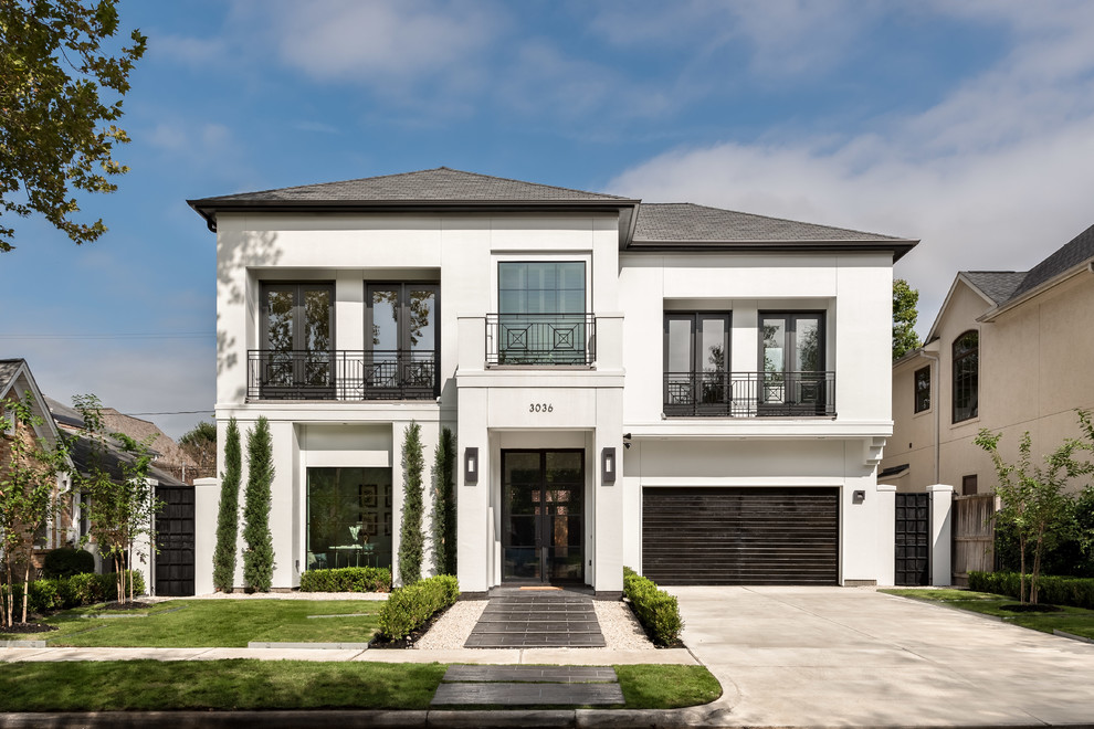 Inspiration for a large transitional two-storey stucco white exterior in Houston with a gable roof.
