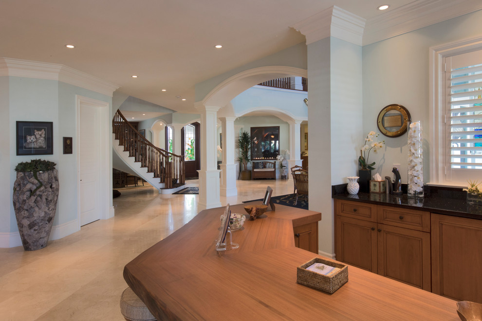 Inspiration for an expansive tropical home bar in Miami with beige floor.