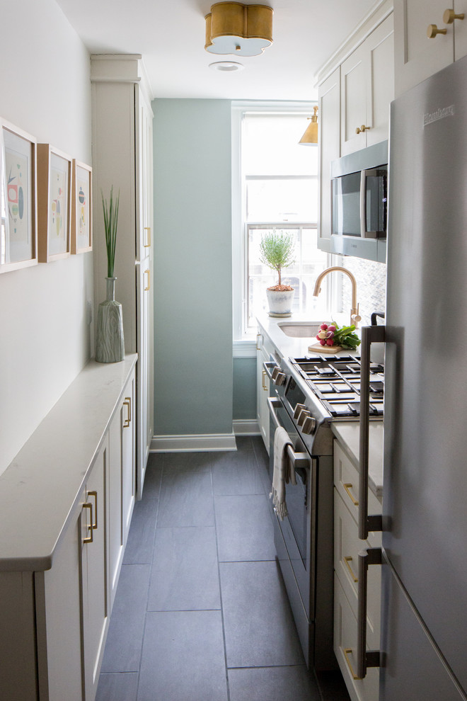 Inspiration for a small transitional galley kitchen remodel in DC Metro with shaker cabinets, white cabinets, glass tile backsplash and stainless steel appliances