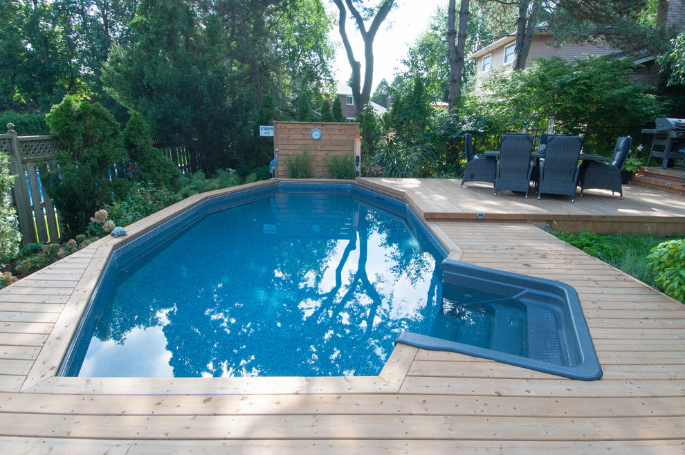 Design ideas for a large traditional swimming pool in Toronto.