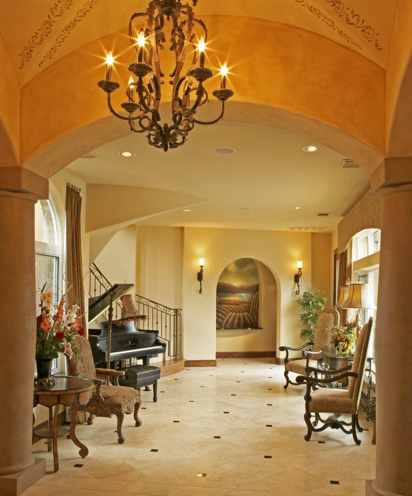Inspiration for an expansive mediterranean foyer in Austin with yellow walls and marble floors.