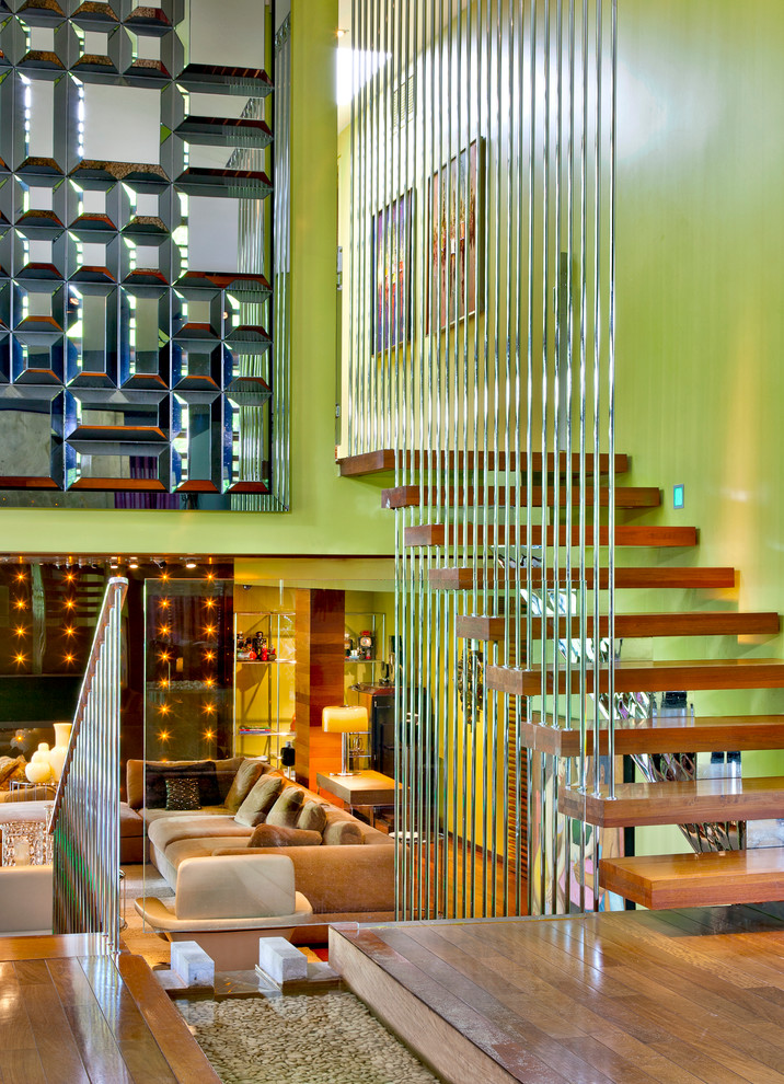 This is an example of a contemporary wood u-shaped staircase in Montreal with open risers.