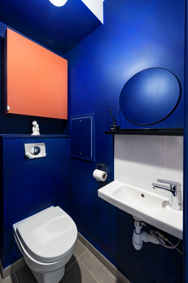 Powder room - contemporary powder room idea in Paris with a floating vanity