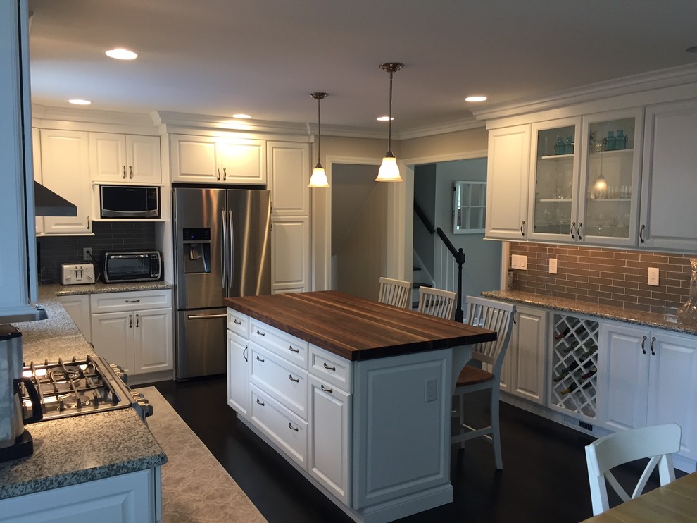 Inspiration for a large traditional l-shaped eat-in kitchen in Nashville with an undermount sink, raised-panel cabinets, white cabinets, wood benchtops, grey splashback, ceramic splashback, stainless steel appliances and with island.