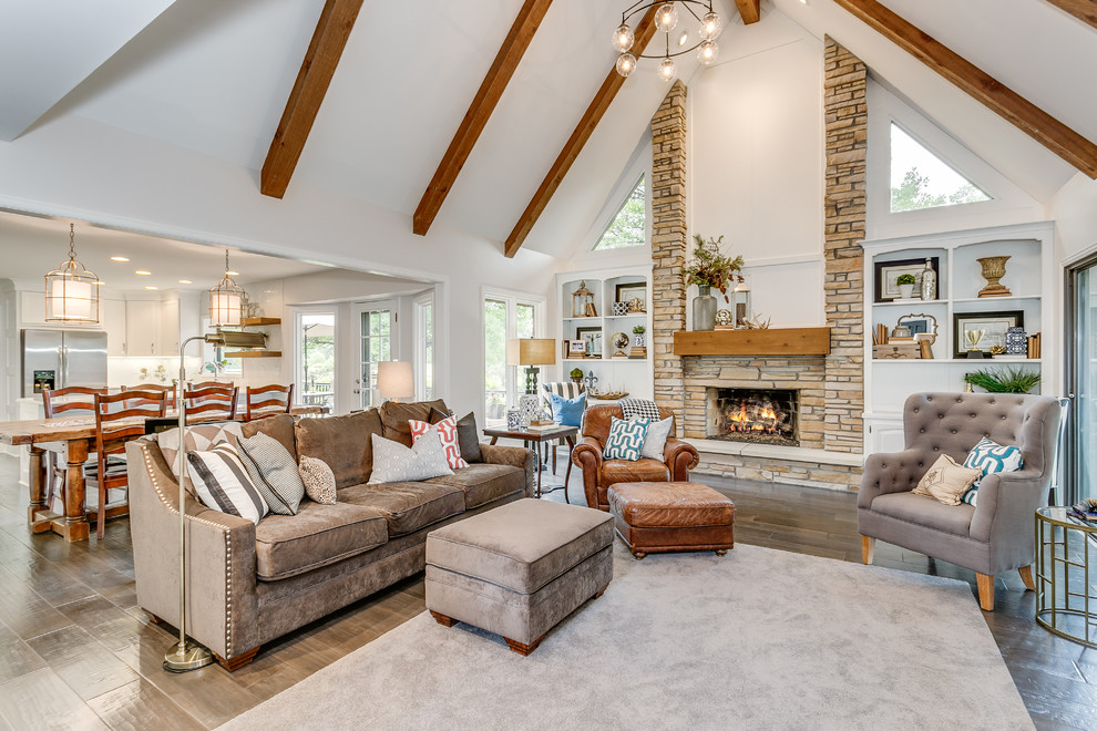 Photo of a country open concept living room in Wichita with white walls, dark hardwood floors, a standard fireplace and a stone fireplace surround.