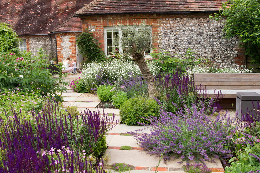 Photo of a country backyard formal garden in Sussex with a garden path and concrete pavers.