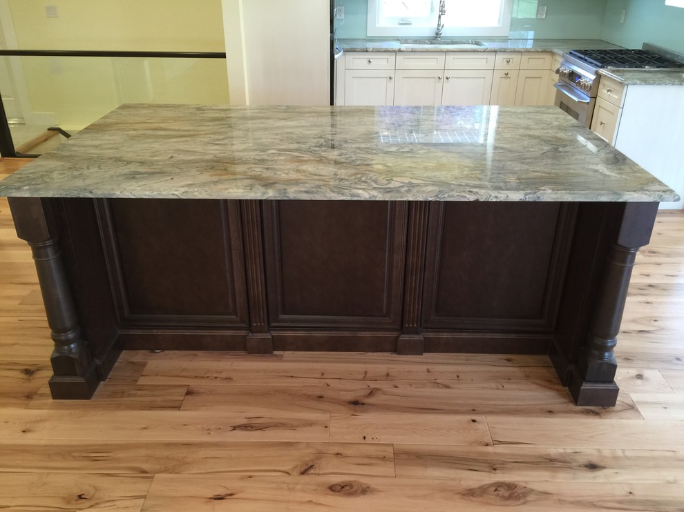 Example of a mid-sized eclectic light wood floor kitchen design in Calgary with an undermount sink, quartzite countertops, stainless steel appliances, an island and glass sheet backsplash