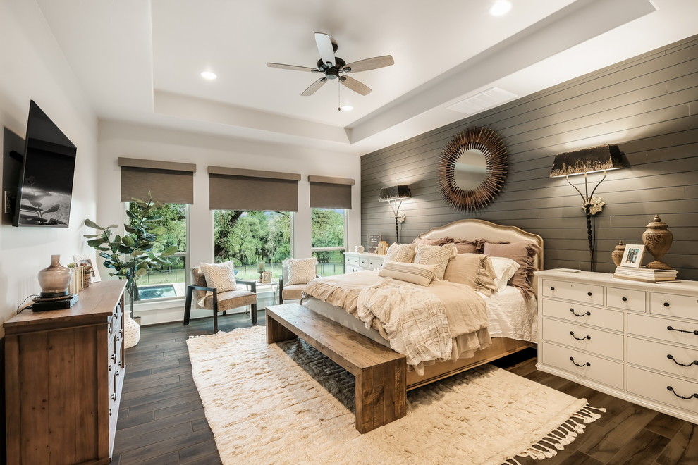 Transitional bedroom in Austin with white walls, medium hardwood floors, no fireplace and brown floor.