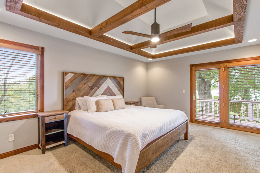 This is an example of a country master bedroom in Milwaukee with beige walls, carpet and beige floor.