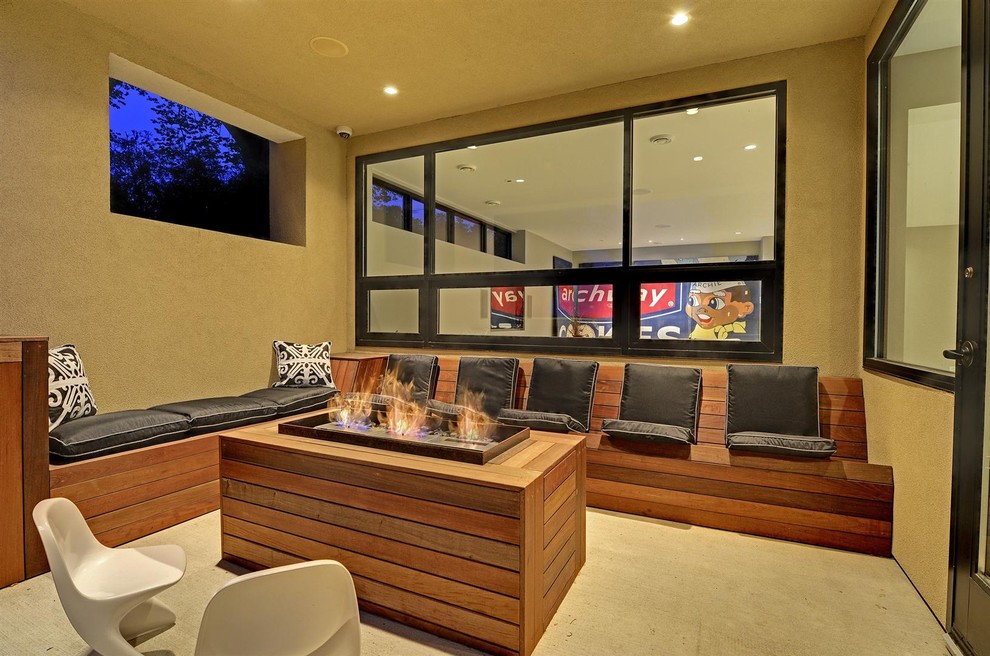 Inspiration for a contemporary patio in Minneapolis with a fire feature and a roof extension.