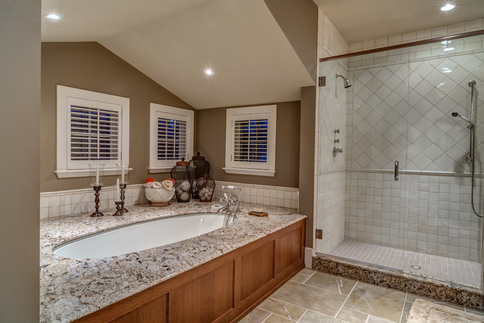This is an example of a large traditional master bathroom in Calgary with an undermount sink, brown walls and an undermount tub.