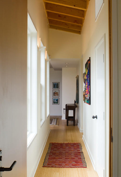 Design ideas for a mid-sized modern hallway in Santa Barbara with white walls and bamboo floors.