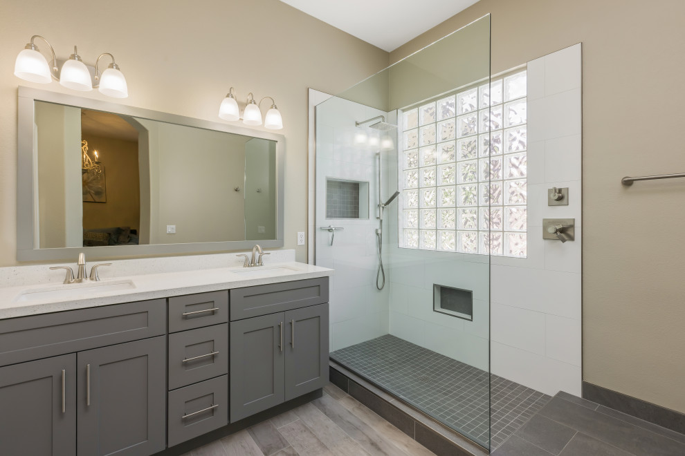 Photo of a medium sized traditional ensuite bathroom in Phoenix with shaker cabinets, grey cabinets, a built-in shower, white tiles, ceramic tiles, beige walls, porcelain flooring, a submerged sink, engineered stone worktops, multi-coloured floors, an open shower, white worktops, a wall niche, double sinks and a built in vanity unit.