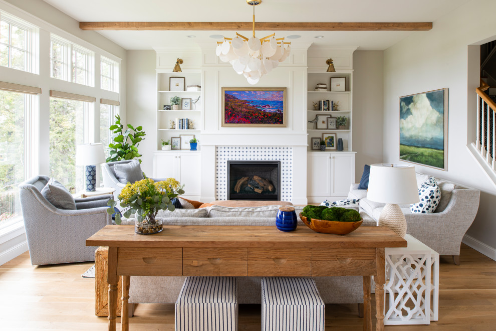Inspiration for a transitional medium tone wood floor, brown floor and exposed beam living room remodel in Minneapolis with a standard fireplace, a tile fireplace, white walls and a wall-mounted tv