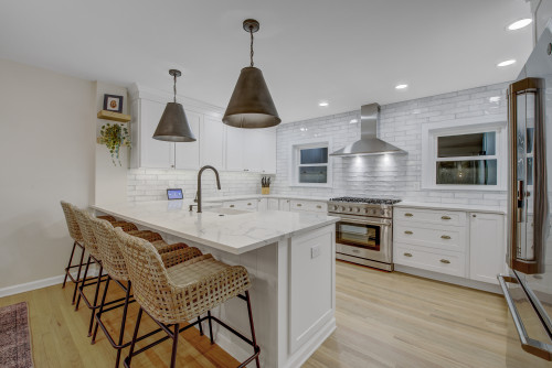 White Philadelphia kitchen with sink in peninsula.