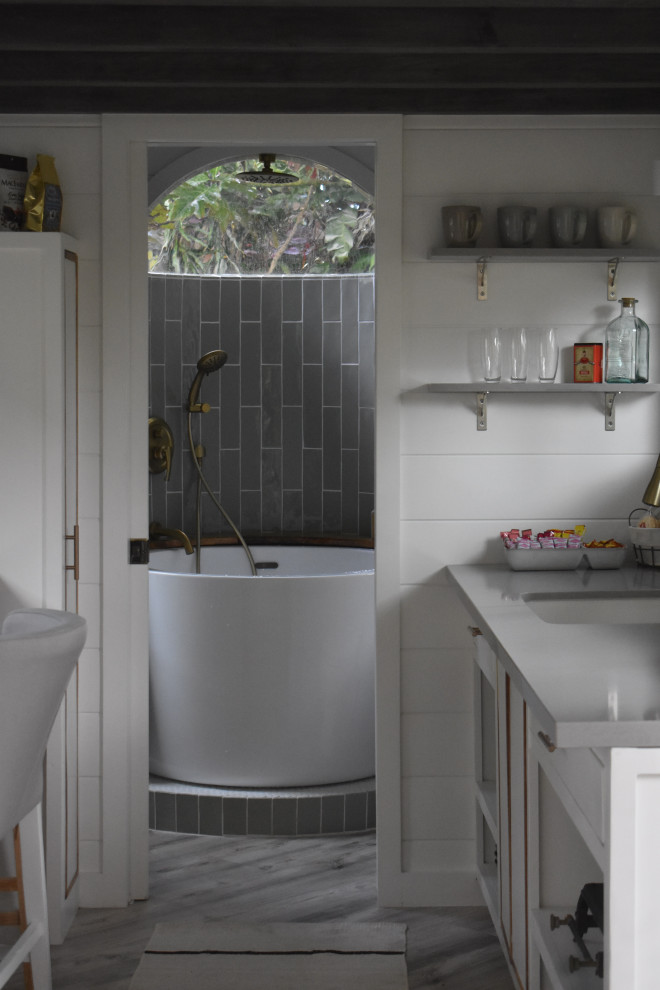 Inspiration for a small contemporary 3/4 white tile gray floor, single-sink, exposed beam and shiplap wall bathroom remodel in Hawaii with open cabinets, white walls, a vessel sink, wood countertops, brown countertops and a floating vanity