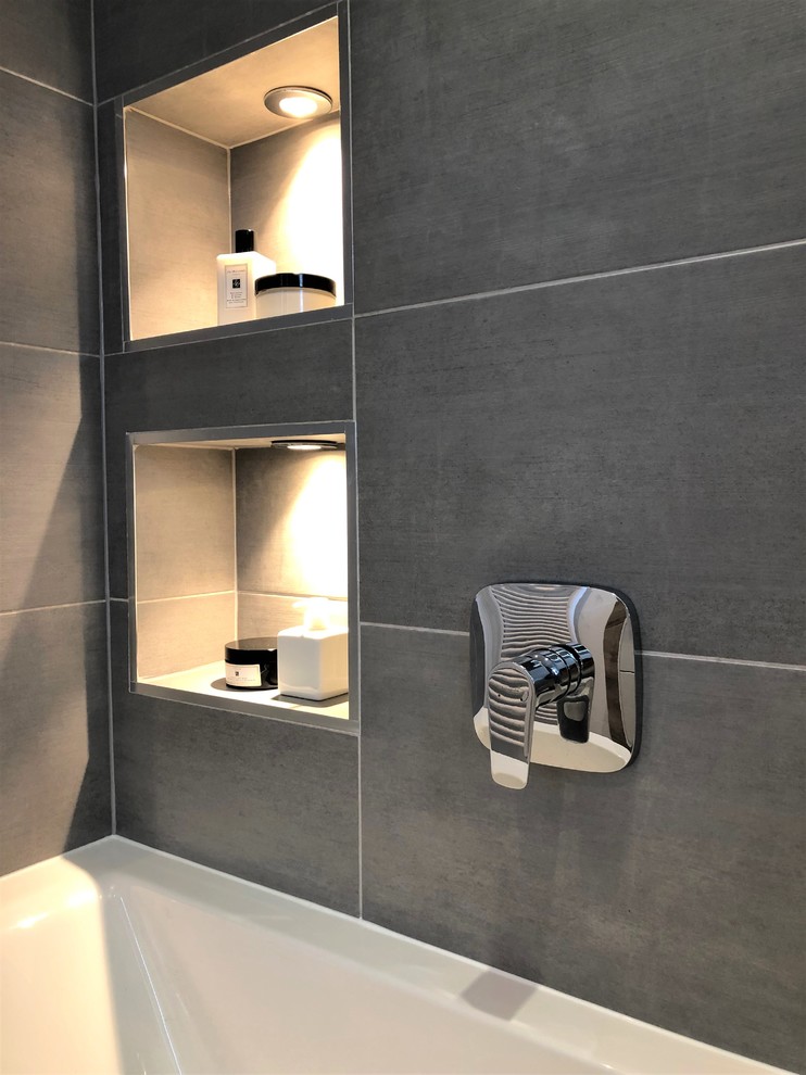 Inspiration for a small contemporary kids bathroom in Other with a drop-in tub, a shower/bathtub combo, porcelain tile, porcelain floors and grey floor.