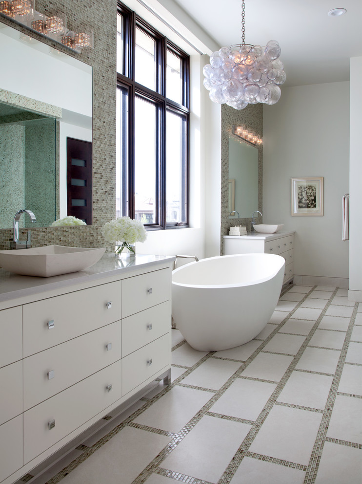 Large transitional master bathroom in Denver with a vessel sink, flat-panel cabinets, white cabinets, quartzite benchtops, a freestanding tub, glass tile, white walls, ceramic floors and beige tile.