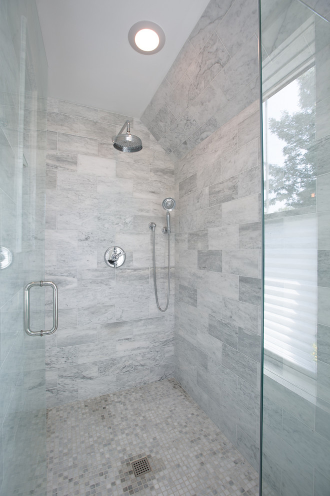 Mid-sized transitional master gray tile and marble tile marble floor and gray floor alcove shower photo in Chicago with recessed-panel cabinets, white cabinets, white walls, an undermount sink, solid surface countertops and a hinged shower door