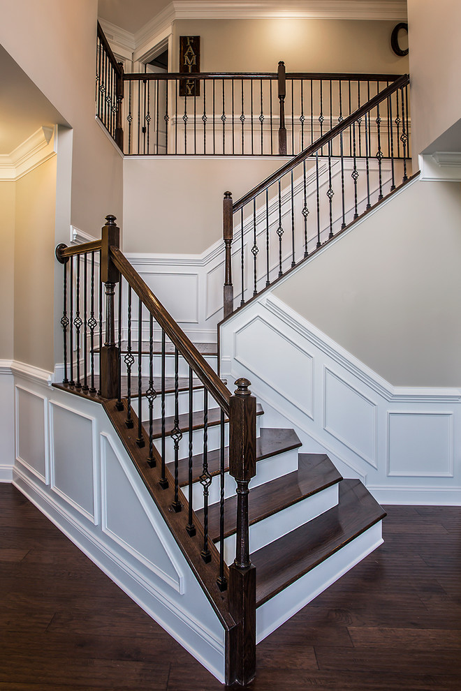 Staircase - mid-sized transitional wooden curved staircase idea in Richmond with wooden risers