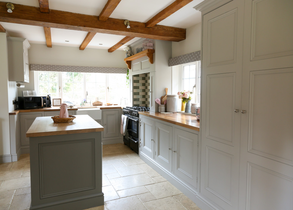 Mid-sized country eat-in kitchen in Surrey with shaker cabinets, grey cabinets, wood benchtops, multi-coloured splashback, ceramic splashback, panelled appliances, with island and brown benchtop.