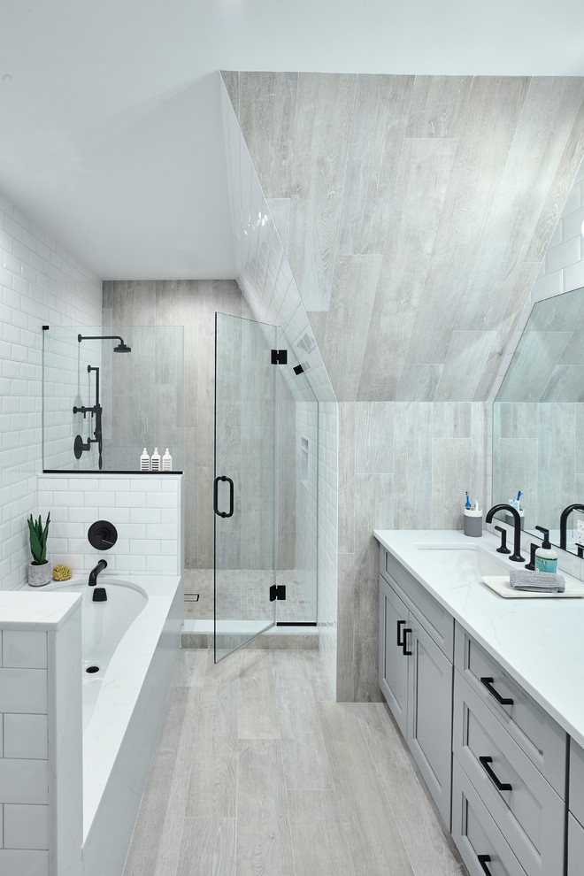 This is an example of a mid-sized contemporary master bathroom in New York with a drop-in tub, gray tile, porcelain tile, porcelain floors, quartzite benchtops, grey floor and white benchtops.