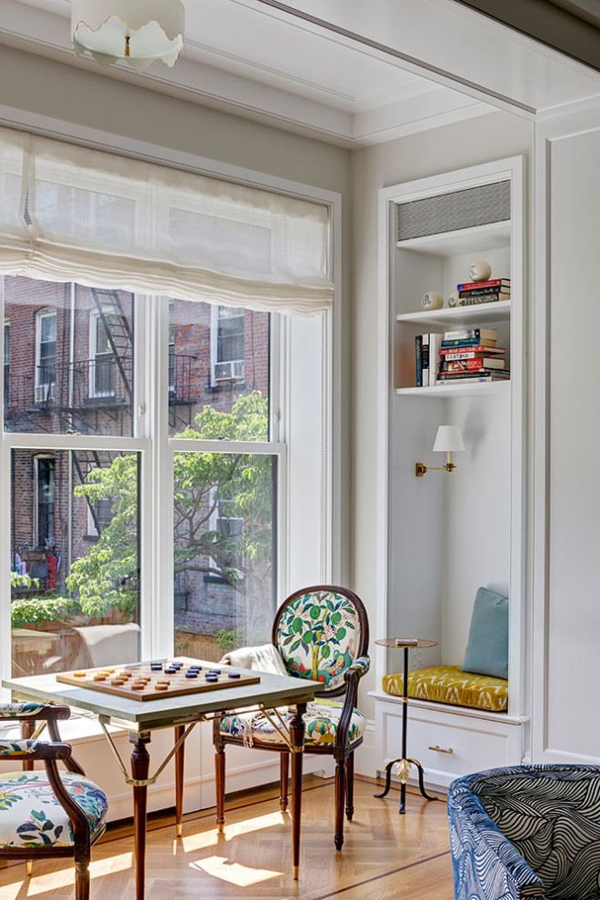This is an example of a large transitional open concept family room in New York with beige walls, no tv, a game room, medium hardwood floors and beige floor.