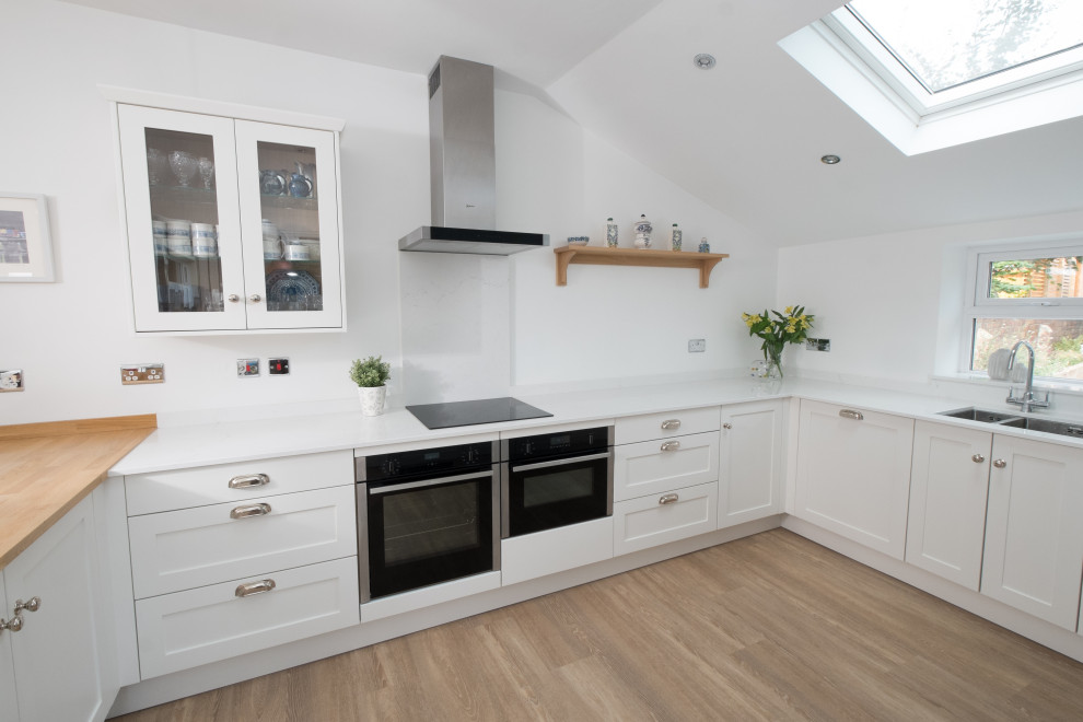 This is an example of a mid-sized beach style kitchen in Cardiff.