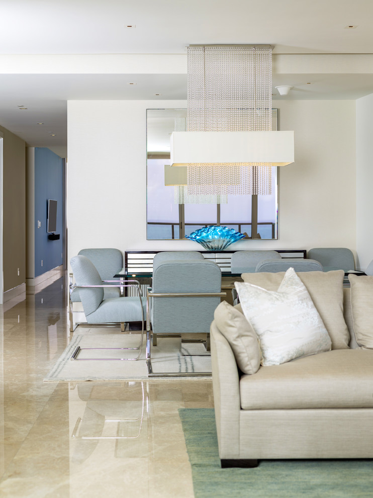 This is an example of a mid-sized contemporary formal open concept living room in Miami with beige walls, limestone floors, no fireplace and no tv.