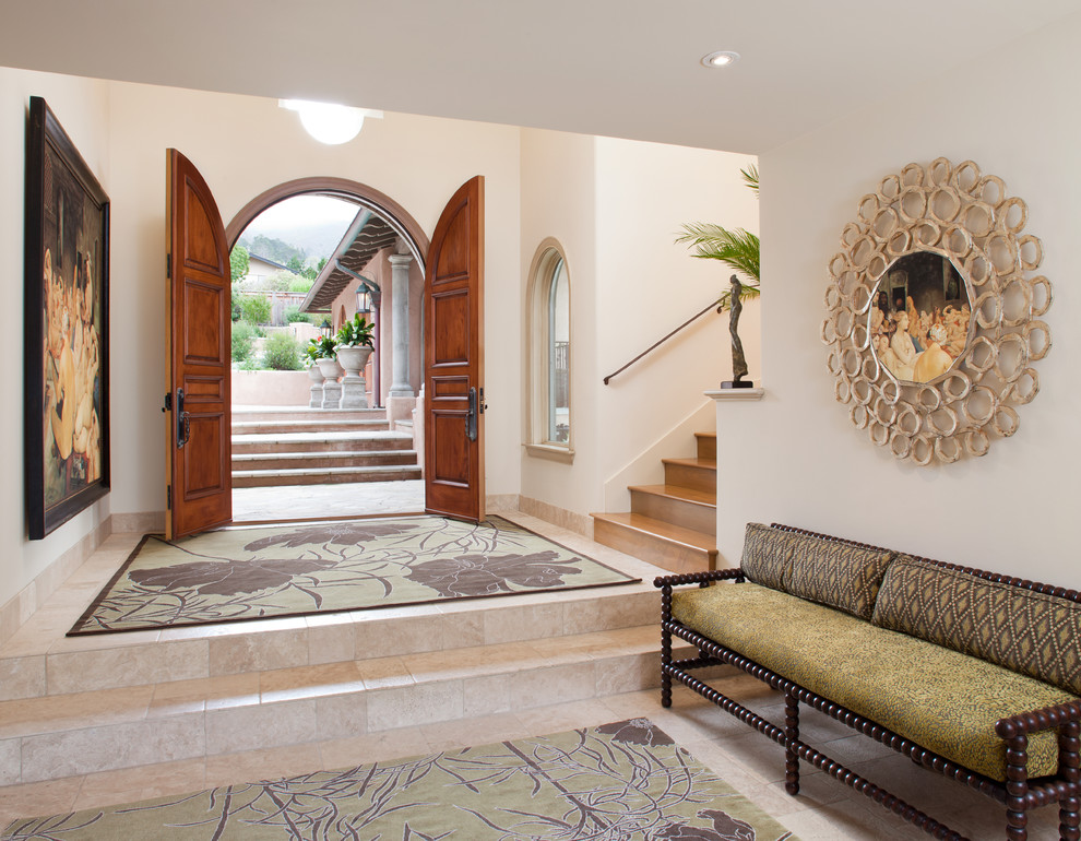 This is an example of a large mediterranean foyer in San Francisco with white walls, a double front door, travertine floors, a medium wood front door and beige floor.