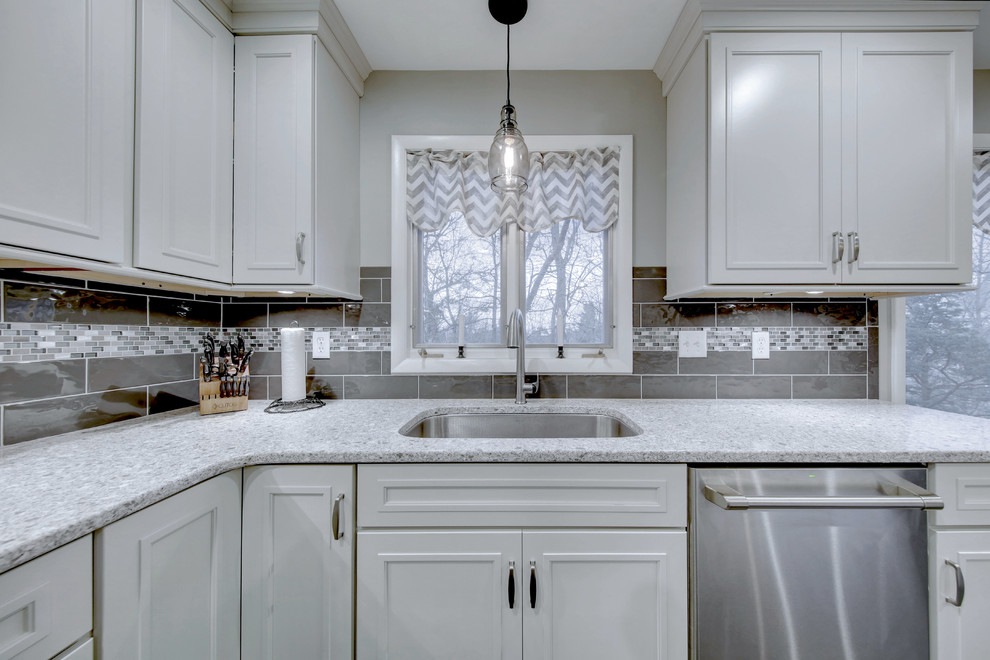 Kitchen - large transitional u-shaped vinyl floor and gray floor kitchen idea with quartz countertops, gray backsplash, mosaic tile backsplash, an island, an undermount sink, beaded inset cabinets, white cabinets and stainless steel appliances