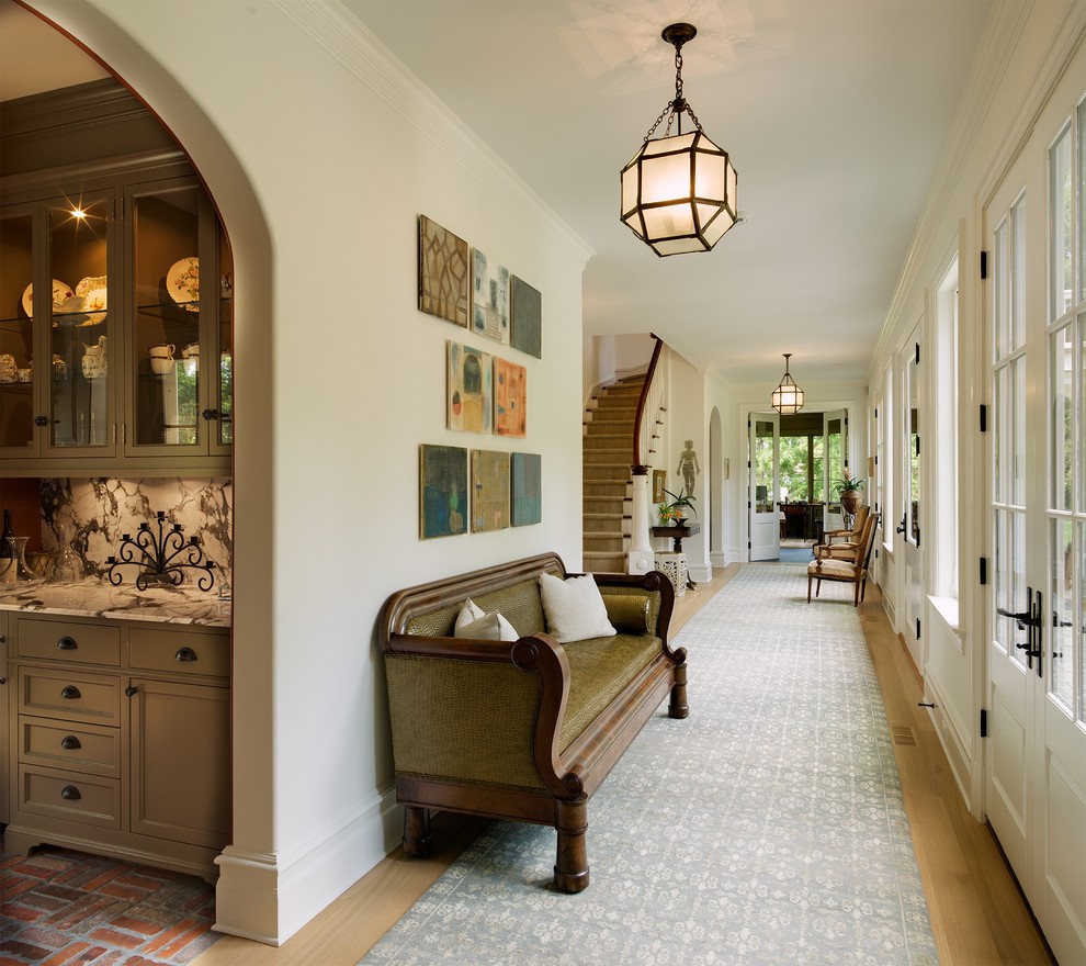 Design ideas for a large traditional hallway in New York with white walls and light hardwood floors.