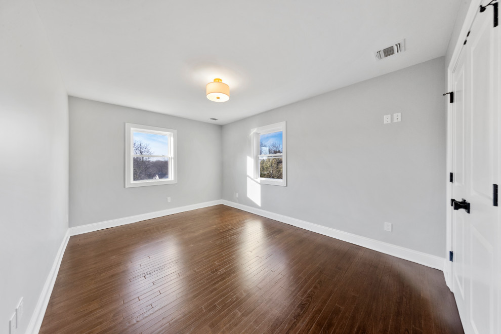 Gray Bedroom with Dual Windows and Closet
