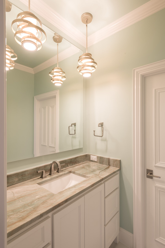 Photo of an expansive transitional kids bathroom in Dallas with shaker cabinets, white cabinets, a one-piece toilet, green walls, porcelain floors, an undermount sink, marble benchtops and beige floor.