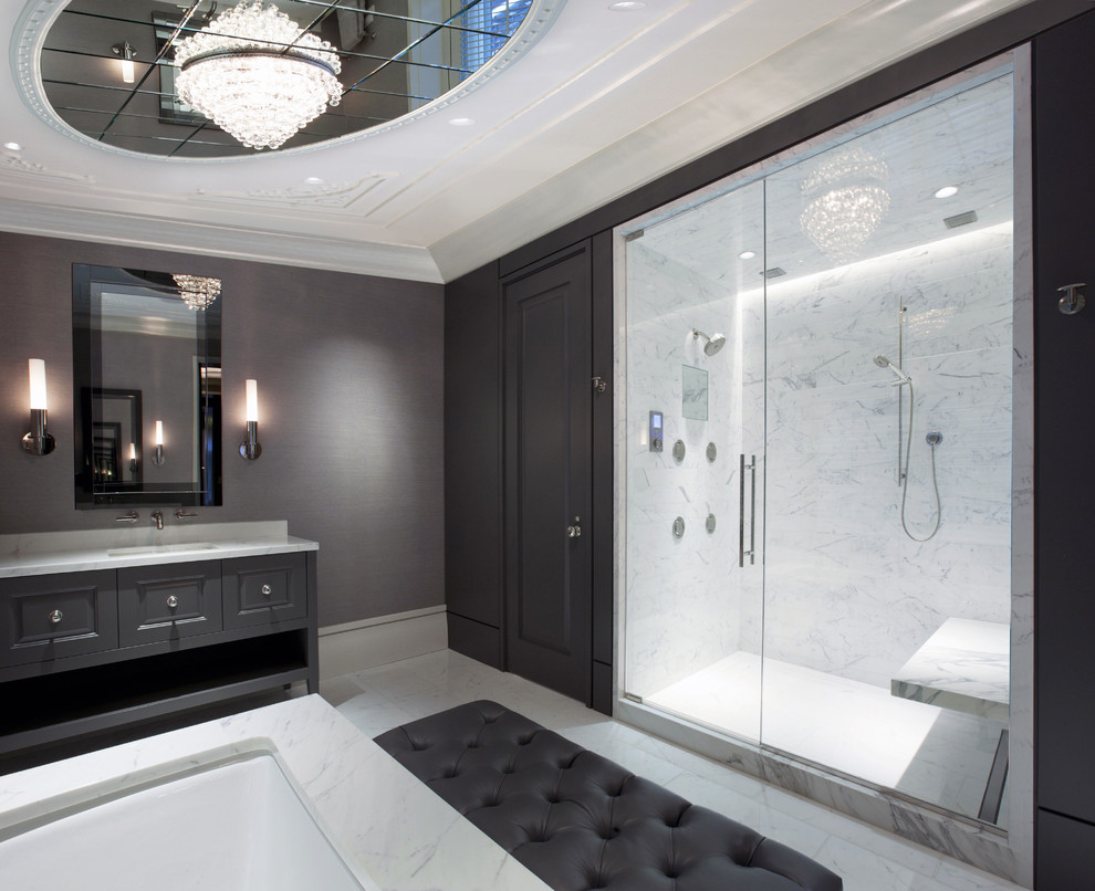 Inspiration for an expansive contemporary master bathroom in Chicago with an undermount sink, raised-panel cabinets, grey cabinets, an alcove shower, white tile, marble benchtops, an undermount tub, grey walls, marble floors, marble and a shower seat.