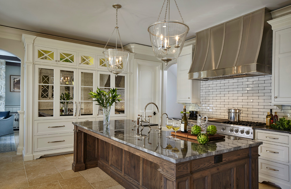 Inspiration for a traditional kitchen in Chicago with recessed-panel cabinets, white cabinets, white splashback, subway tile splashback, stainless steel appliances and with island.