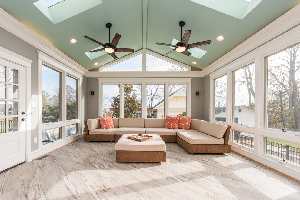 This is an example of a large transitional sunroom in DC Metro with ceramic floors, no fireplace, a skylight and grey floor.