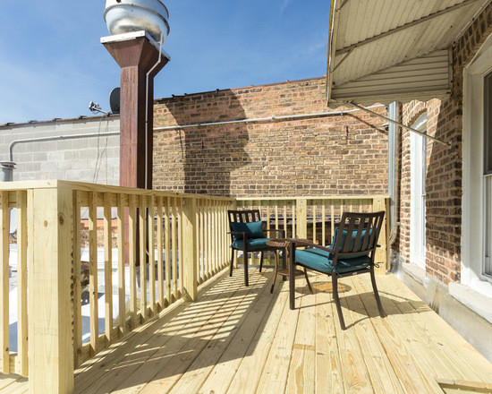 Inspiration for a mid-sized eclectic rooftop deck in Chicago with with dock and an awning.