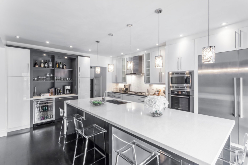 Inspiration for a large contemporary l-shaped eat-in kitchen in Toronto with a single-bowl sink, flat-panel cabinets, white cabinets, quartz benchtops, white splashback, marble splashback, stainless steel appliances, dark hardwood floors, with island, grey floor and grey benchtop.