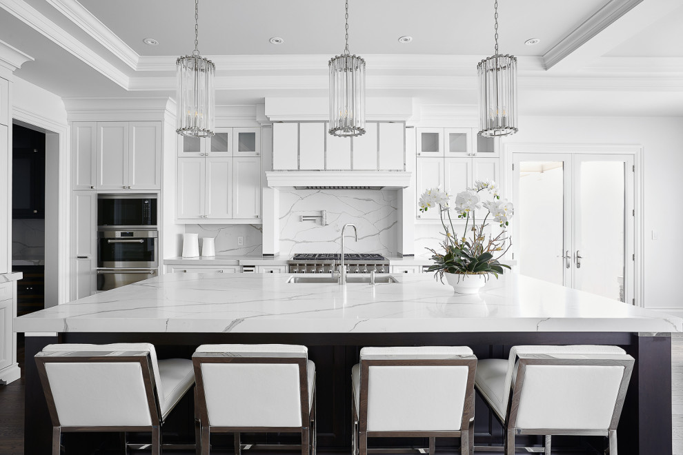 Inspiration for a large transitional tray ceiling eat-in kitchen remodel in Toronto with an undermount sink, recessed-panel cabinets, white cabinets, quartzite countertops, multicolored backsplash, stainless steel appliances, an island and multicolored countertops