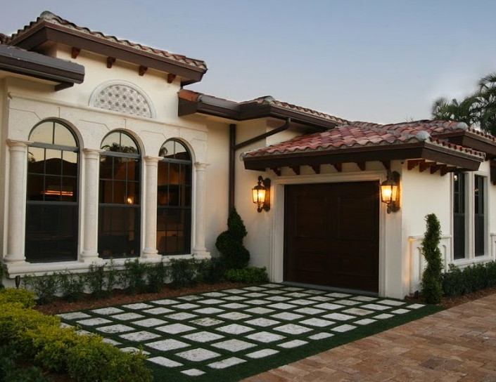 This is an example of a small mediterranean one-storey stucco white exterior in Miami.