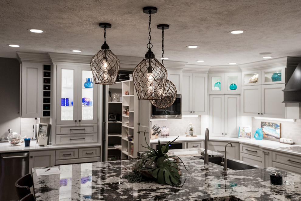 Inspiration for a mid-sized transitional eat-in kitchen remodel with shaker cabinets, white cabinets, quartz countertops, stainless steel appliances and an island