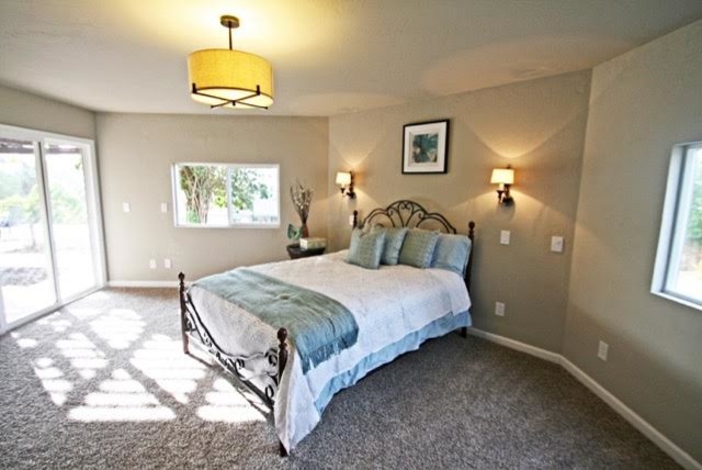 This is an example of a traditional bedroom in San Diego with carpet.